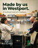 A man and a woman wearing white lab coats and blue gloves work together in a laboratory setting, with shelves of supplies in the background. Large text at the top reads 'Made by us in Westport.